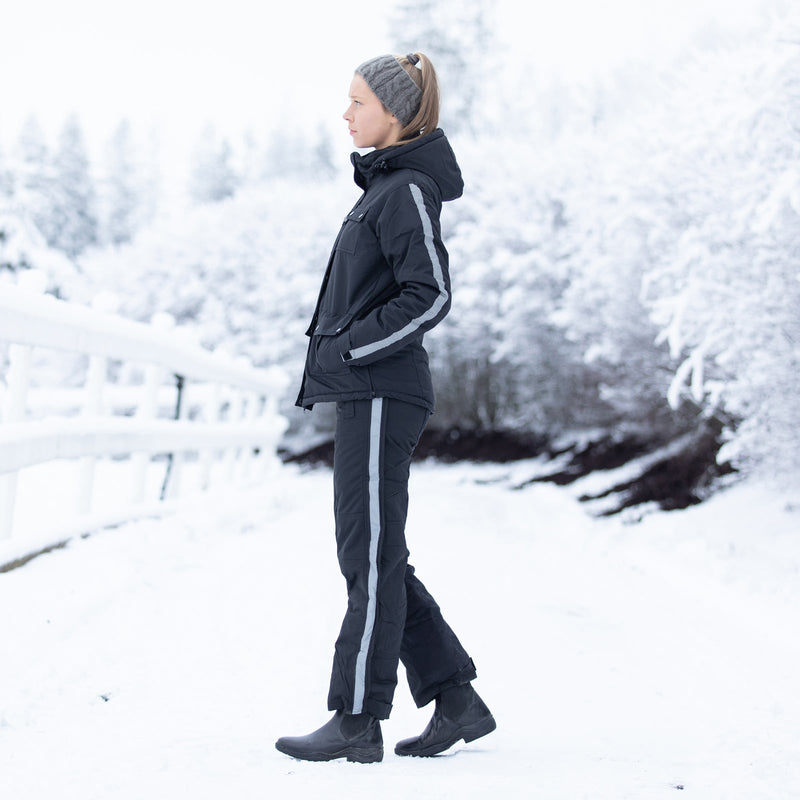 Girl in snow wearing Black Horze Kids Winter Rider Pants Breeches Small